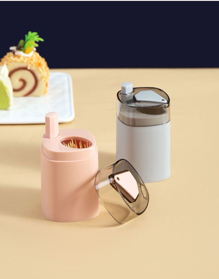 Pop-up toothpick dispenser presenting a single toothpick