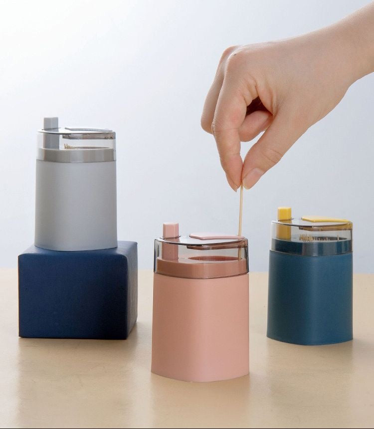 Pop-up toothpick dispenser presenting a single toothpick