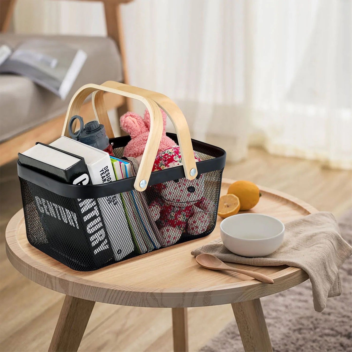 Black storage basket on living room shelf for organizing books and toys