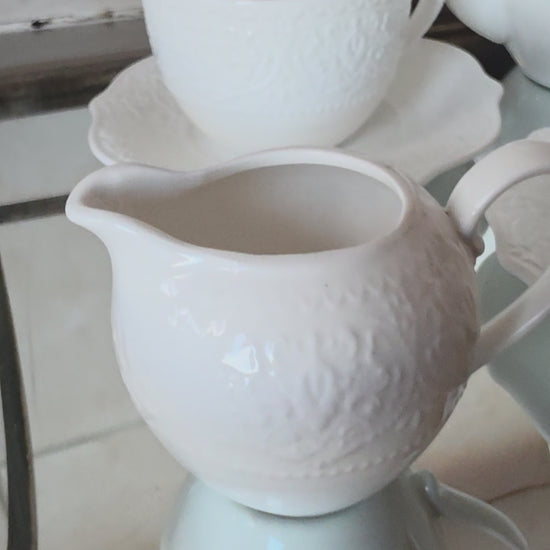 Coordinated cups and saucers from 14-piece tea set stacked together