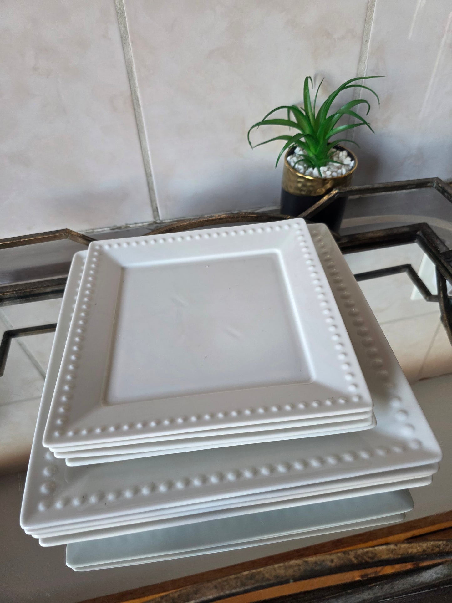Set of 8 elegant dinner plates arranged on dining table